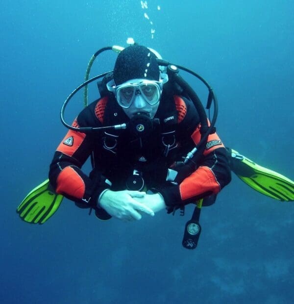 Diver underwater in full scuba gear.