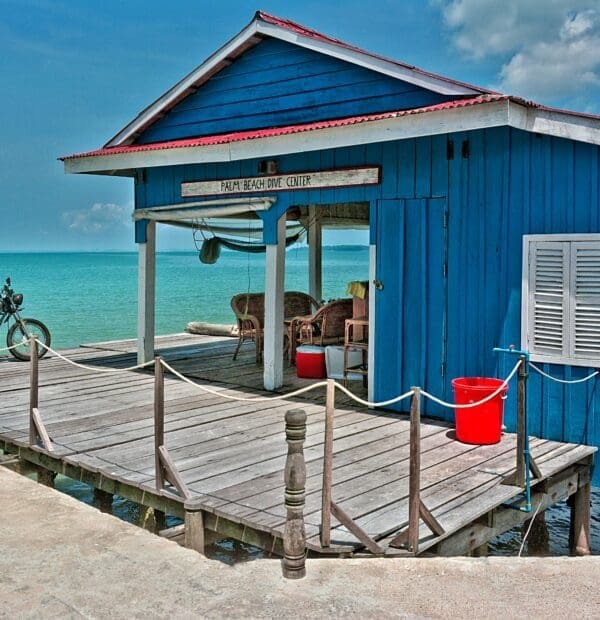 Blue seaside shack with motorcycle, Palm Beach Dive Center.