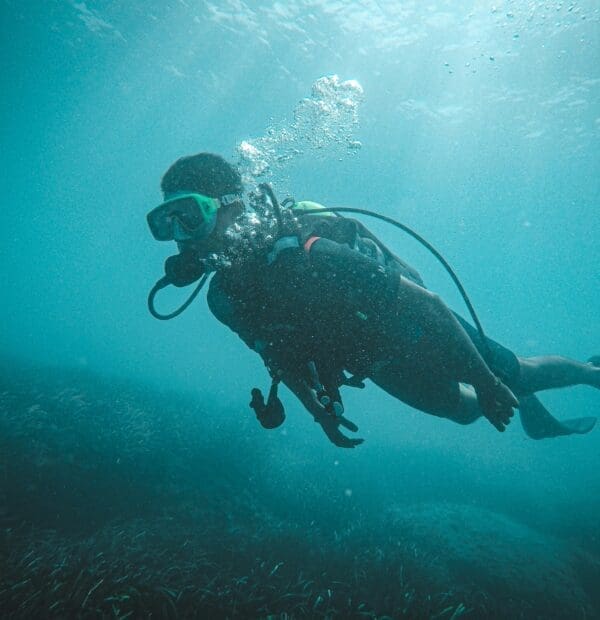 Scuba diver exploring underwater with clear visibility.