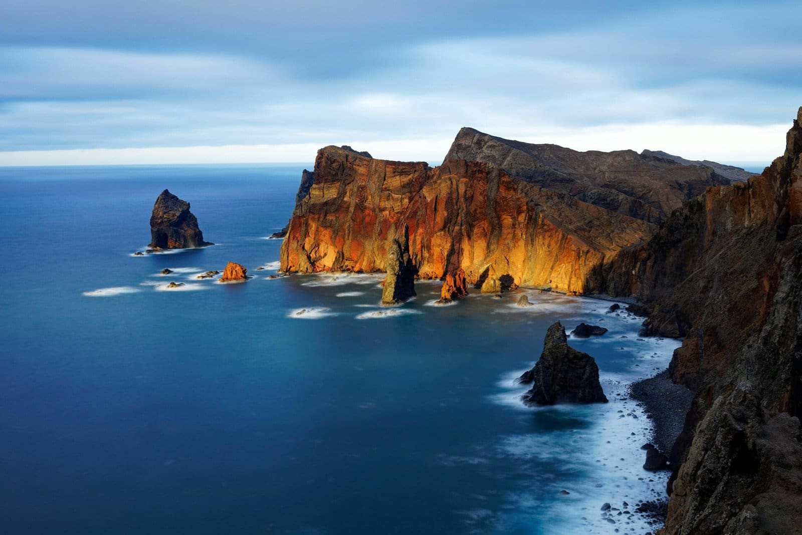 Dramatic coastal cliffs over serene blue ocean