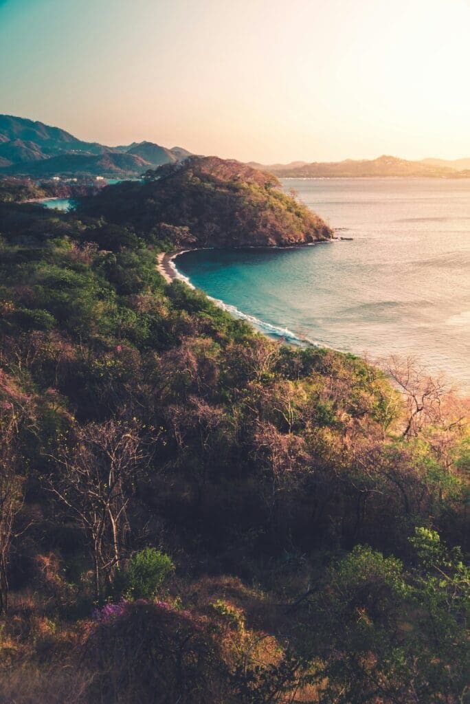 Scenic coastal view with lush hills and turquoise water