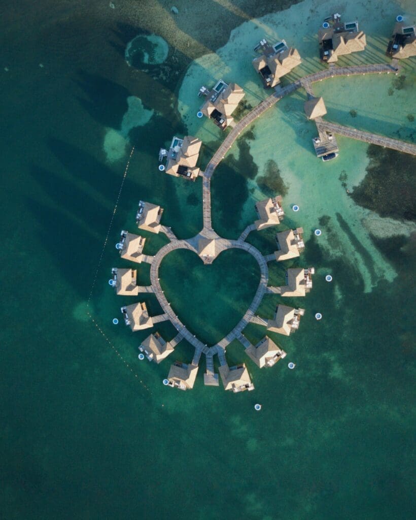 Heart-shaped overwater bungalows in tropical blue sea