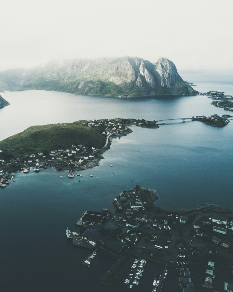 Aerial view of coastal village surrounded by mountains