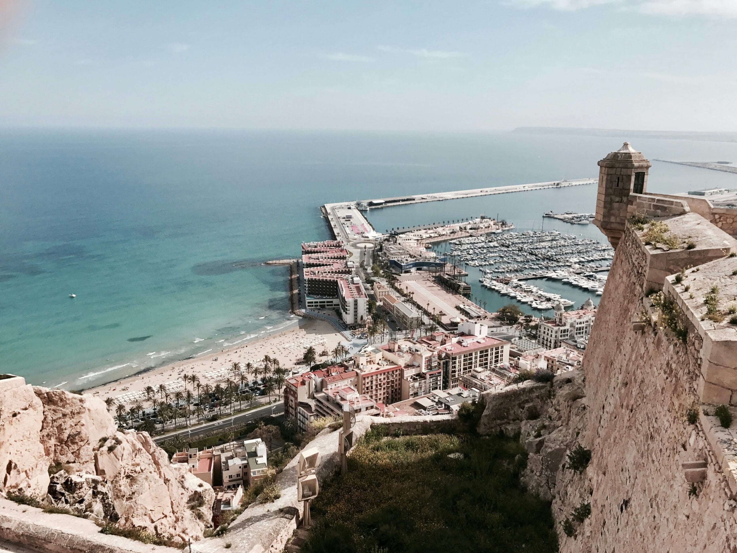 Aerial view of coastal city with marina and beach