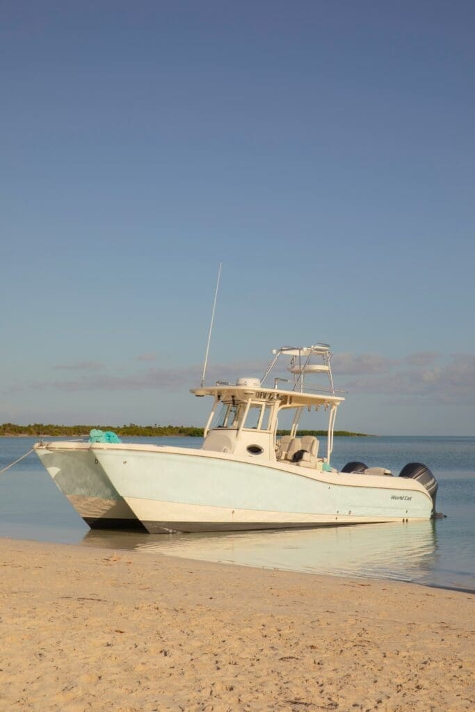 Motorboat moored on tranquil beach at sunset