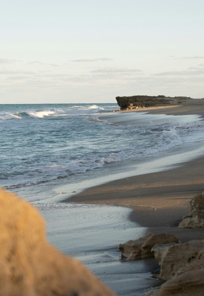 Serene beach with rocky outcrop and gentle waves