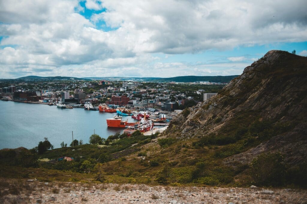 Coastal cityscape viewed from rocky hillside