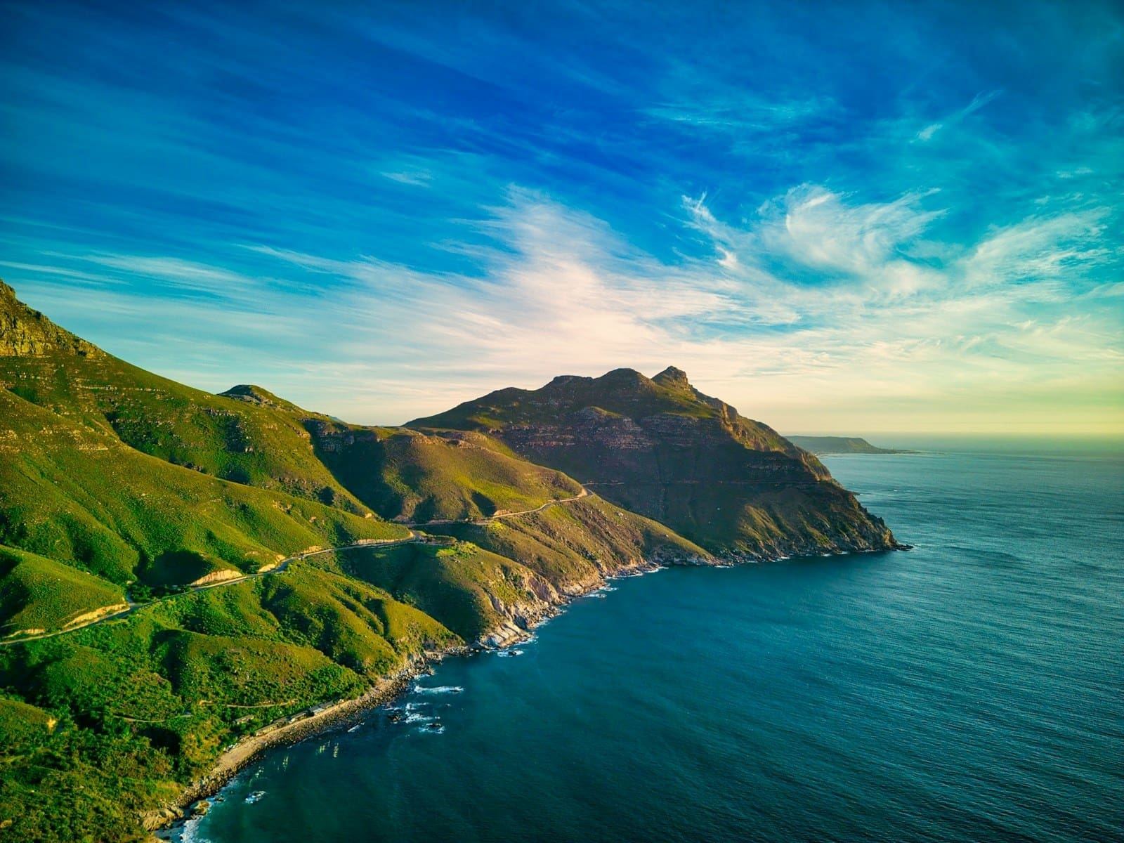 a scenic view of the ocean and mountains